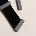 Adjustable size on grey ankle weights laying on beige background