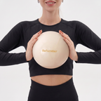 kvinna håller en mini ilatesboll i svarta kläder