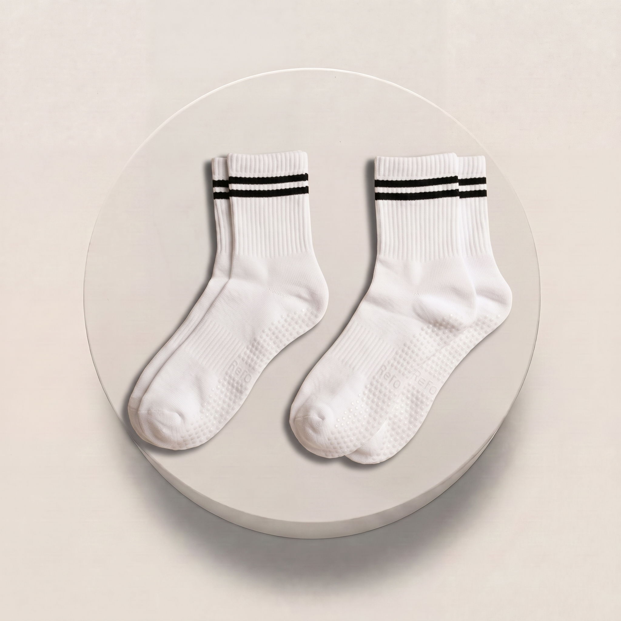 white pilates grip socks on podium